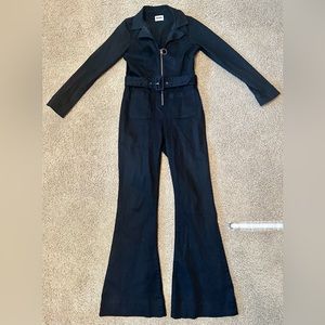 Show Me Your MuMu, long sleeve black jumpsuit. Gold zipper/gold belt grommets.